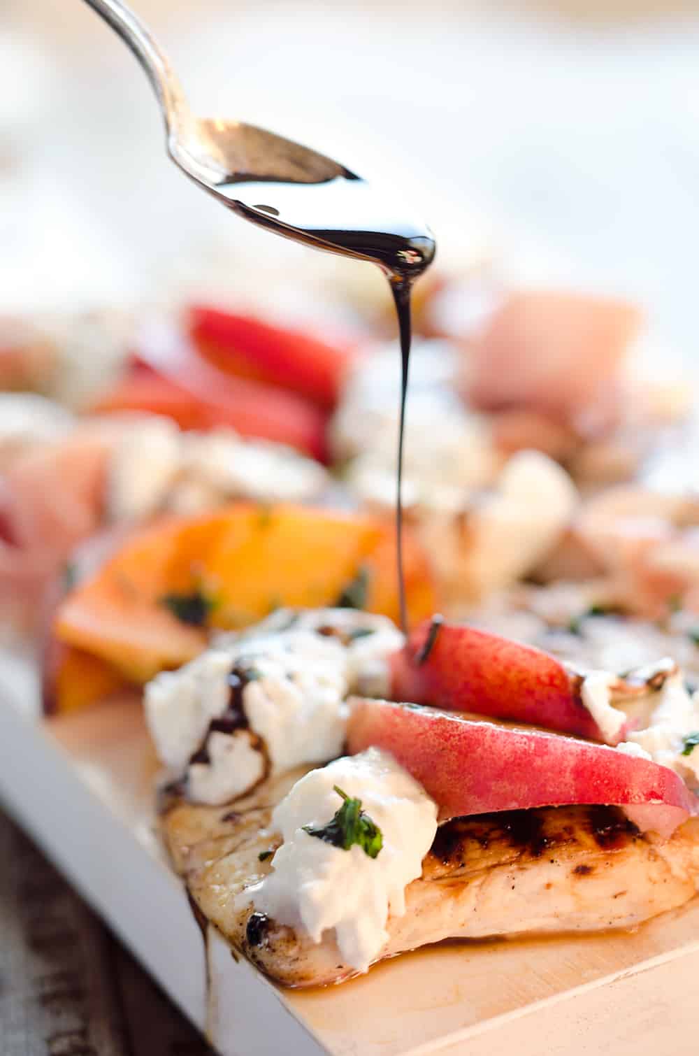 Balsamic Chicken with Peaches & Prosciutto is a deliciously simple and healthy dinner made on the grill in just 10 minutes! Grilled chicken is topped with fresh peaches and burrata cheese and finished off with a balsamic reduction and basil for a combination of flavors you will love. 