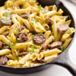 cast iron skillet with pasta and chicken sausage