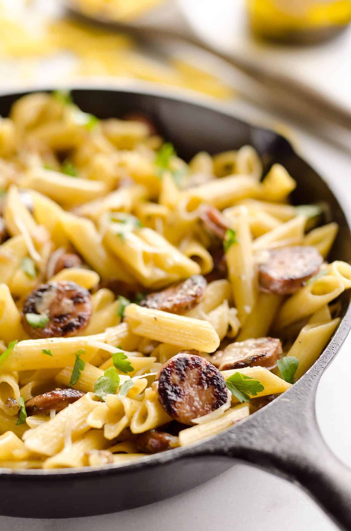 Chicken Sausage & Penne Skillet is an easy gluten free dinner idea loaded with rich flavors. Penne Pasta is tossed with a white wine and Parmesan cream sauce along with chicken apple sausage and shallots for a hearty dinner bursting with amazing flavor. 