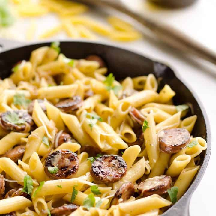Chicken Sausage & Penne Skillet is an easy gluten free dinner idea loaded with rich flavors. Penne Pasta is tossed with a white wine and Parmesan cream sauce along with chicken apple sausage and shallots for a hearty dinner bursting with amazing flavor.
