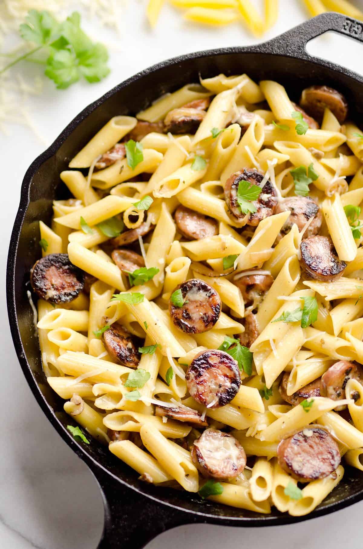 Chicken Sausage & Penne Skillet is an easy gluten free dinner idea loaded with rich flavors. Penne Pasta is tossed with a white wine and Parmesan cream sauce along with chicken apple sausage and shallots for a hearty dinner bursting with amazing flavor.