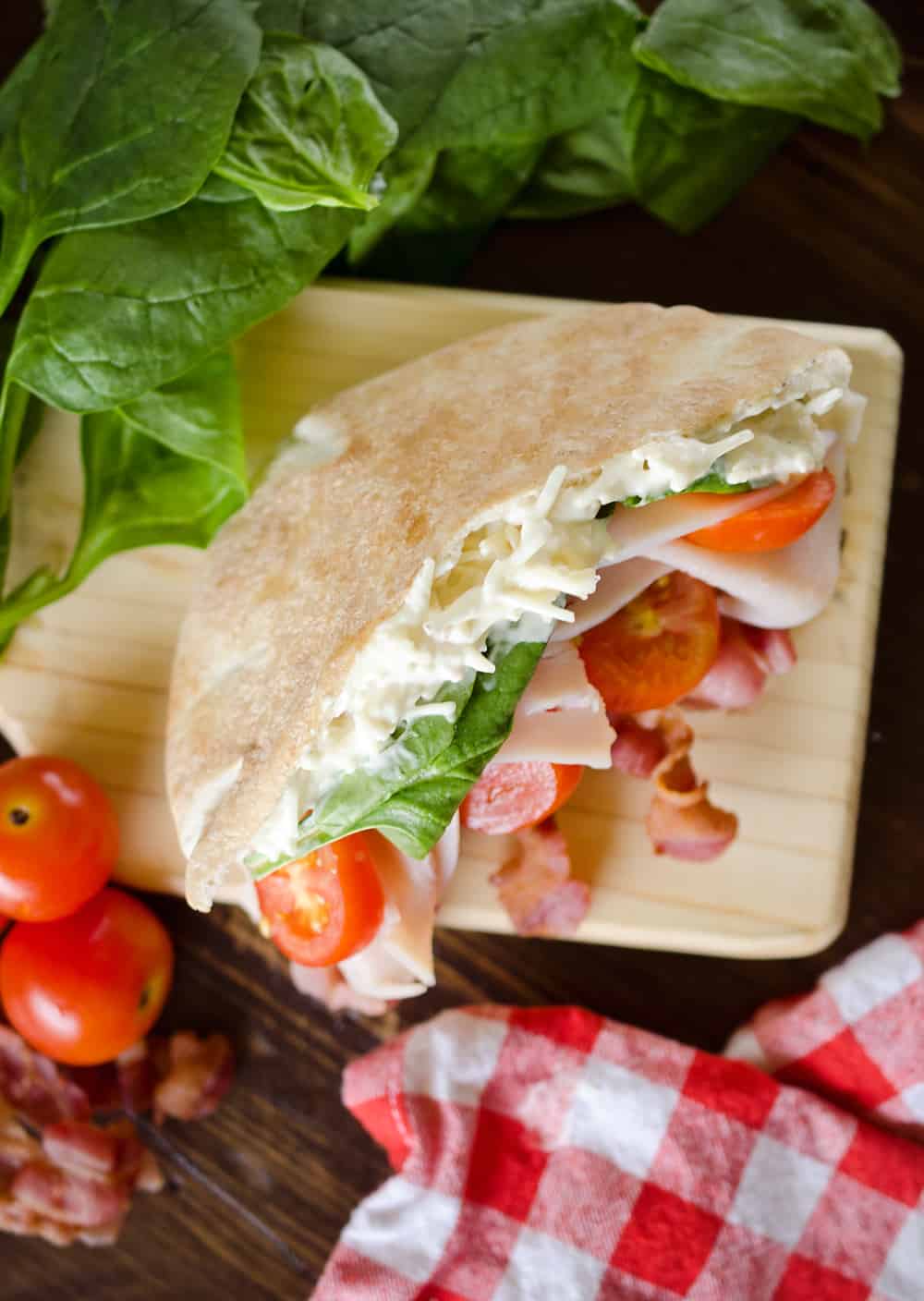 Parmesan Ranch Turkey BLT Pita is an easy and flavorful lunch loaded with bacon, lettuce, tomato, turkey and a delicious parmesan ranch. This sandwich recipe is perfect for a quick summer lunch everyone will love!