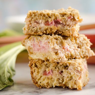 Rhubarb Custard Oatmeal Bars are a fun twist on a favorite summer treat. Fresh rhubarb and custard are layered with chewy oatmeal layers for a dessert that everyone will love!