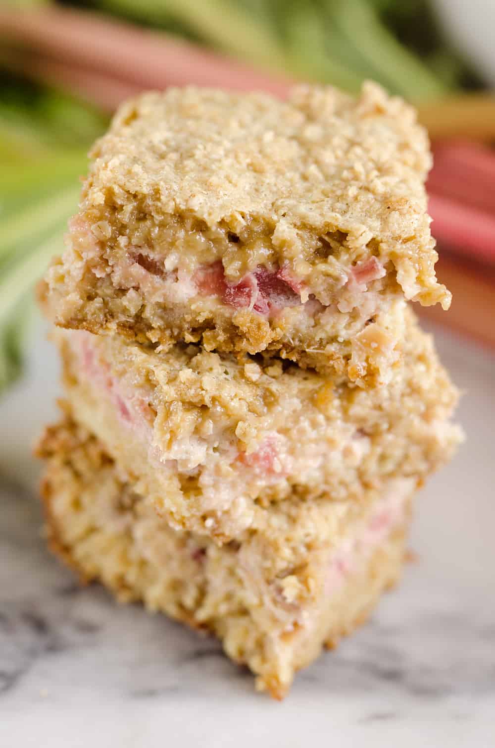 Rhubarb Custard Oatmeal Bars are a fun twist on a favorite summer treat. Fresh rhubarb and custard are layered with chewy oatmeal layers for a dessert that everyone will love!