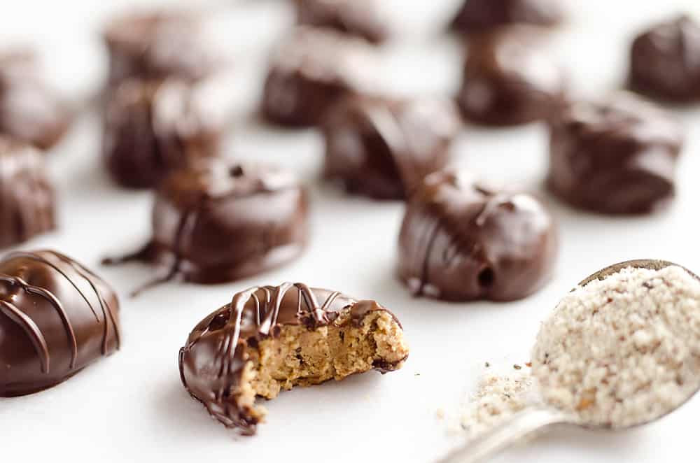 Protein Peanut Butter Truffles are an amazing 100 calorie treat packed with protein powder, chia seeds and coated in dark chocolate for healthy a dessert you can feel good about!