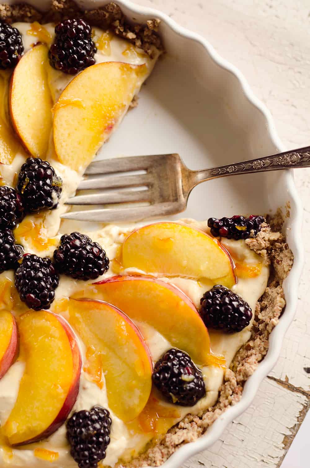 Light Peach & Berry Tart is a lightened up dessert loaded with an orange, cream cheese and Greek yogurt layer and topped with fresh peaches and berries for a spectacular sweet!