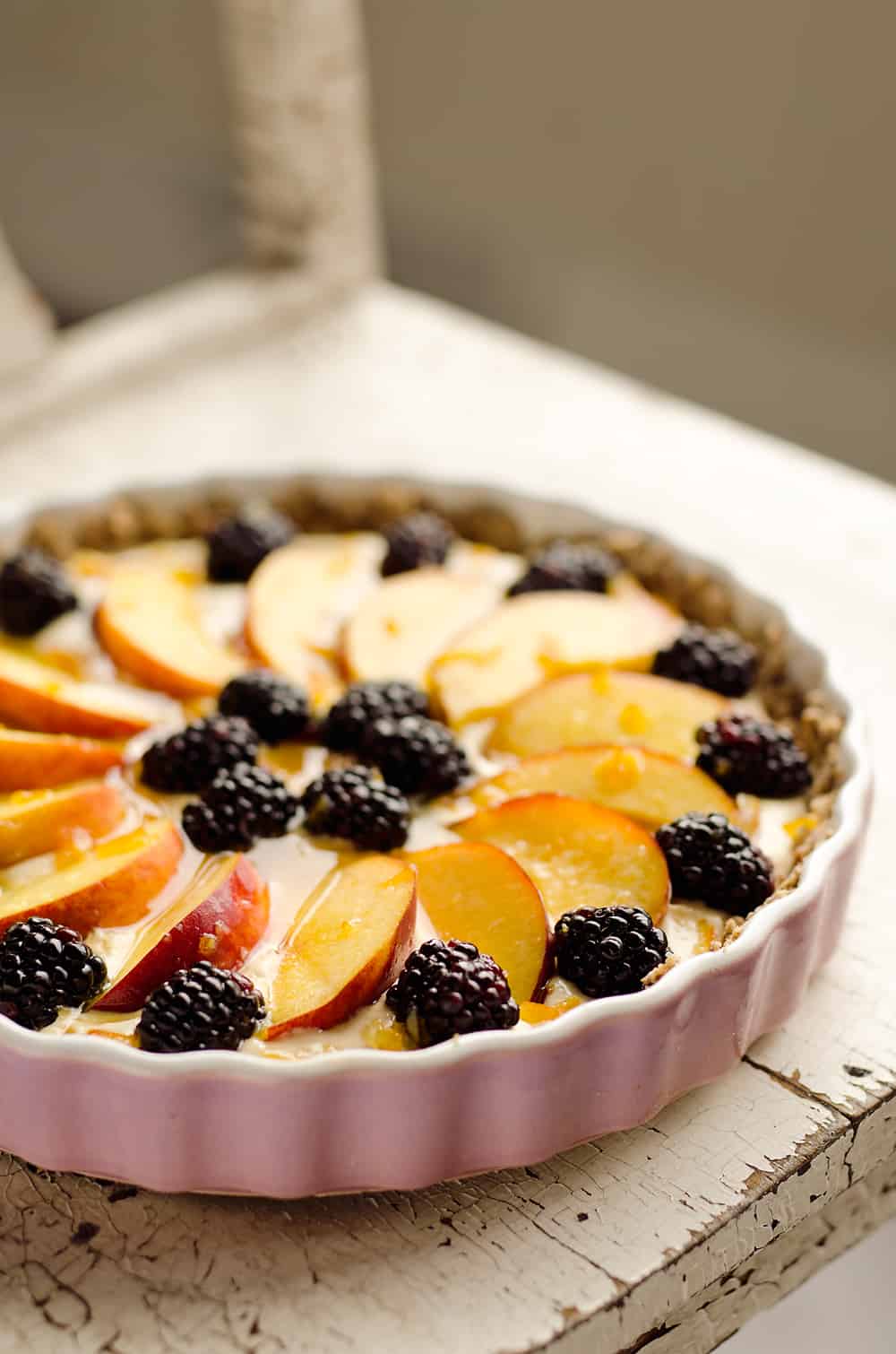 Light Peach & Berry Tart is a lightened up dessert loaded with an orange, cream cheese and Greek yogurt layer and topped with fresh peaches and berries for a spectacular sweet!