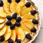 Light Peach & Berry Tart is a lightened up dessert loaded with an orange, cream cheese and Greek yogurt layer and topped with fresh peaches and berries for a spectacular sweet!