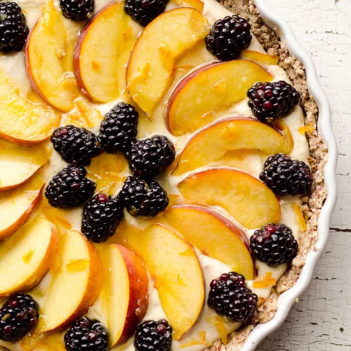 Light Peach & Berry Tart is a lightened up dessert loaded with an orange, cream cheese and Greek yogurt layer and topped with fresh peaches and berries for a spectacular sweet!