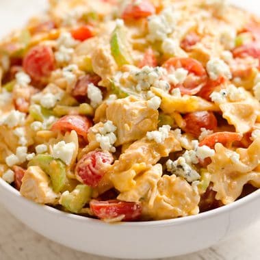 Buffalo Chicken Pasta Salad is a quick and easy recipe perfect for a game day party or a summer picnic. Tender pasta is tossed with a creamy buffalo sauce and fresh vegetables all topped off with crumbled bleu cheese for a side dish bursting with flavor and crunch!
