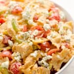 Buffalo Chicken Pasta Salad is a quick and easy recipe perfect for a game day party or a summer picnic. Tender pasta is tossed with a creamy buffalo sauce and fresh vegetables all topped off with crumbled bleu cheese for a side dish bursting with flavor and crunch!