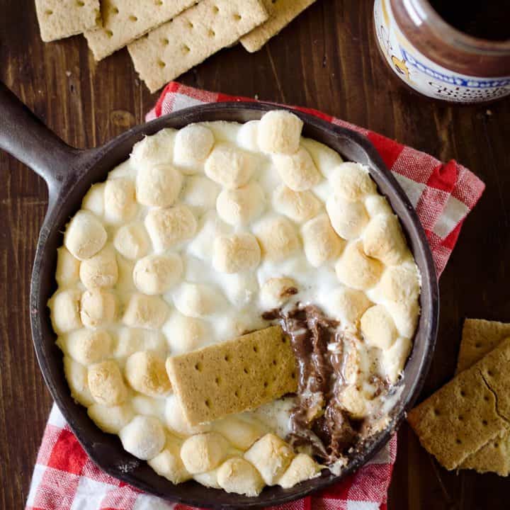 Peanut Butter S'mores Dip is the perfect sweet treat any time of year! It's made with just three ingredients and none of the smokey mess of the traditional dessert. Enjoy all the great flavors of S'mores with a peanut butter twist for a family friendly treat!