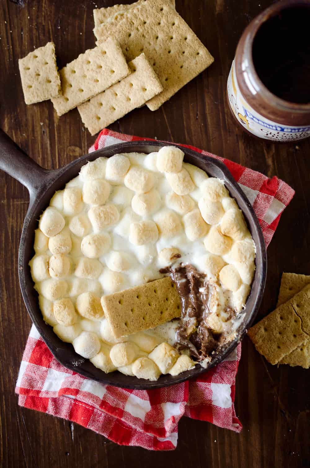 Peanut Butter S'mores Dip is the perfect sweet treat any time of year! It's made with just three ingredients and none of the smokey mess of the traditional dessert. Enjoy all the great flavors of S'mores with a peanut butter twist for a family friendly treat!