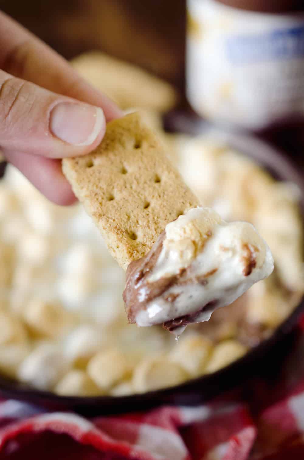 Peanut Butter S'mores Dip is the perfect sweet treat any time of year! It's made with just three ingredients and none of the smokey mess of the traditional dessert. Enjoy all the great flavors of S'mores with a peanut butter twist for a family friendly treat!