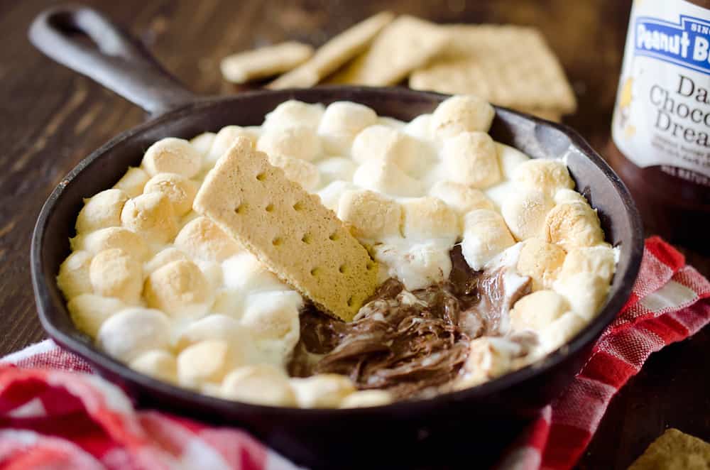 Peanut Butter S'mores Dip is the perfect sweet treat any time of year! It's made with just three ingredients and none of the smokey mess of the traditional dessert. Enjoy all the great flavors of S'mores with a peanut butter twist for a family friendly treat!