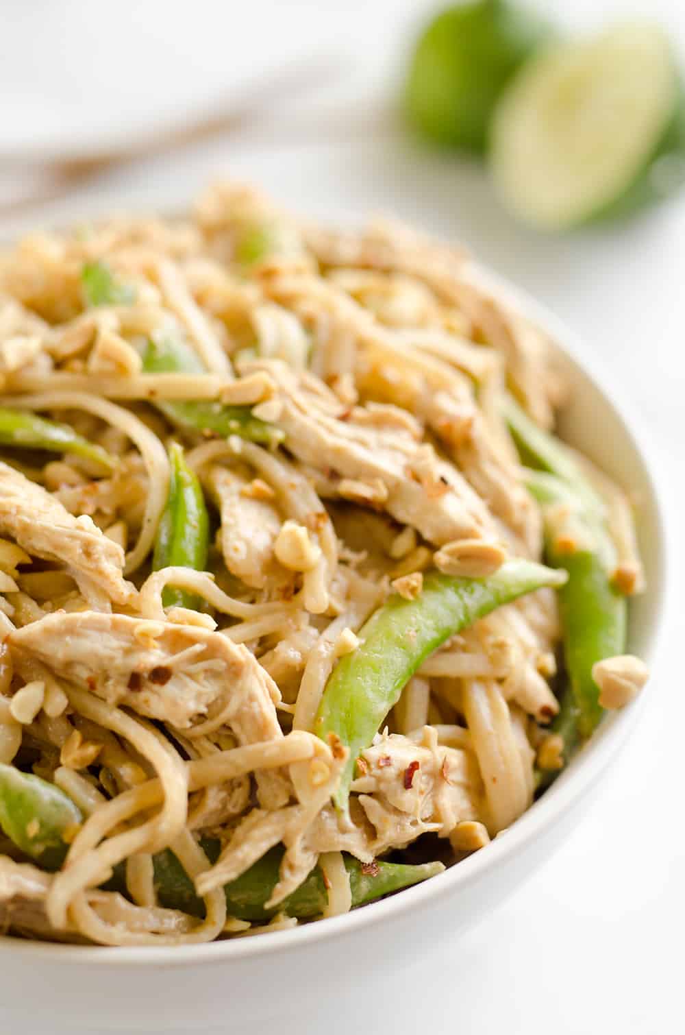 Pressure Cooker Thai Peanut Chicken & Noodles is the best 30 minute Pressure Cooker recipe you will find! Lean chicken breasts are cooked in a homemade spicy Thai peanut sauce and finished off with rice noodles and peas for an easy and healthy one-pot meal made in your Instant Pot. 