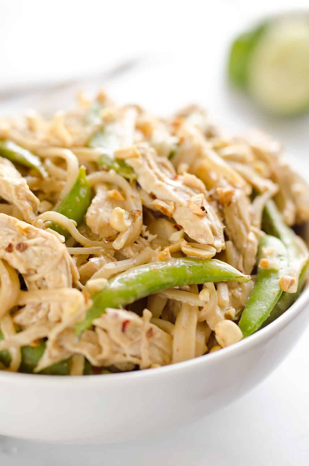 Pressure Cooker Thai Peanut Chicken & Noodles is the best 30 minute Pressure Cooker recipe you will find! Lean chicken breasts are cooked in a homemade spicy Thai peanut sauce and finished off with rice noodles and peas for an easy and healthy one-pot meal made in your Instant Pot.