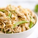 Pressure Cooker Thai Peanut Chicken & Noodles is the best 30 minute Pressure Cooker recipe you will find! Lean chicken breasts are cooked in a homemade spicy Thai peanut sauce and finished off with rice noodles and peas for an easy and healthy one-pot meal made in your Instant Pot.