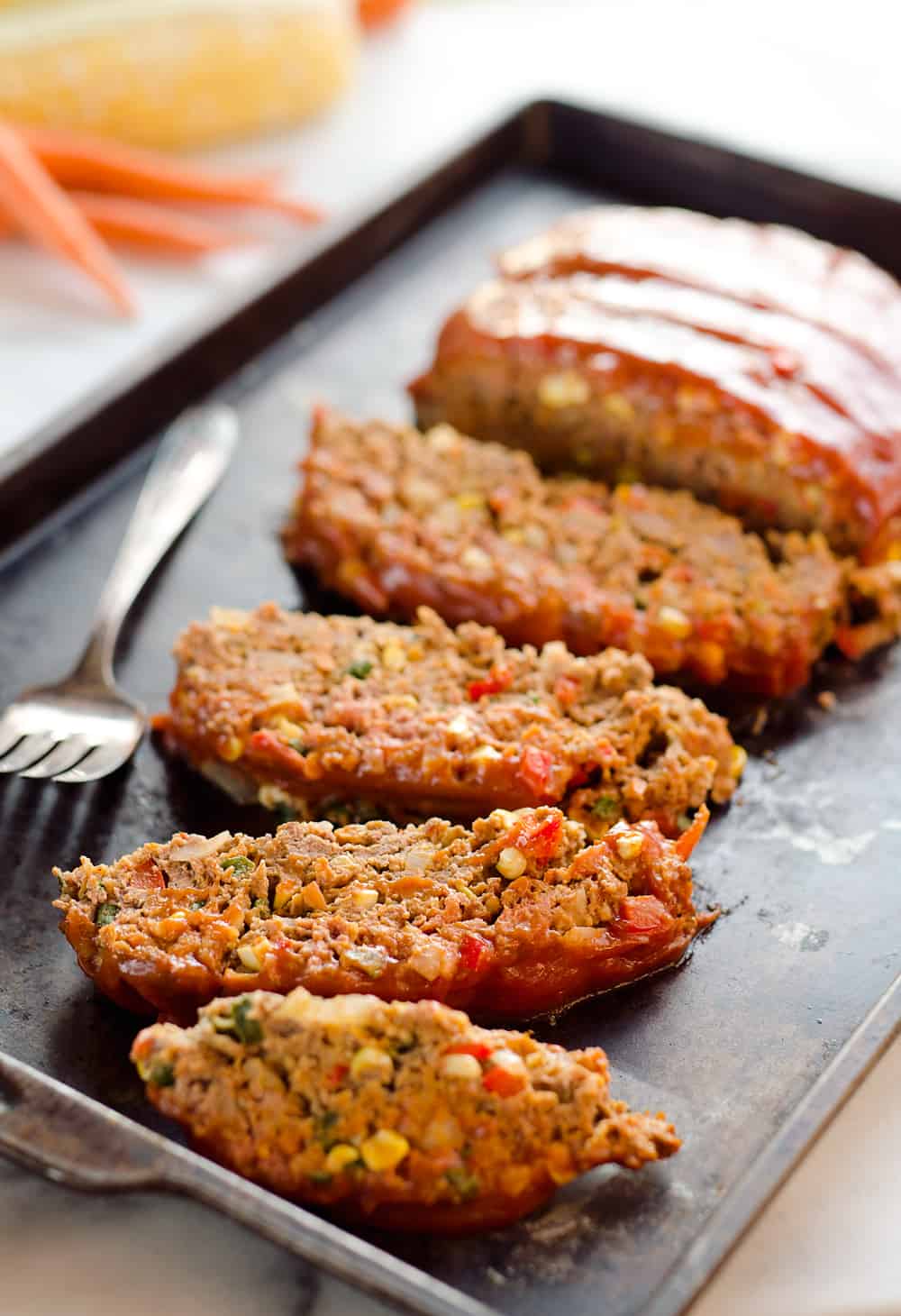 Ultimate Chorizo Meatloaf is a hearty dinner full of ground beef, chorizo, sweet corn and lots of veggies! Take your meatloaf to the next level with this spicy and flavorful recipe that is sure to be a winner. 