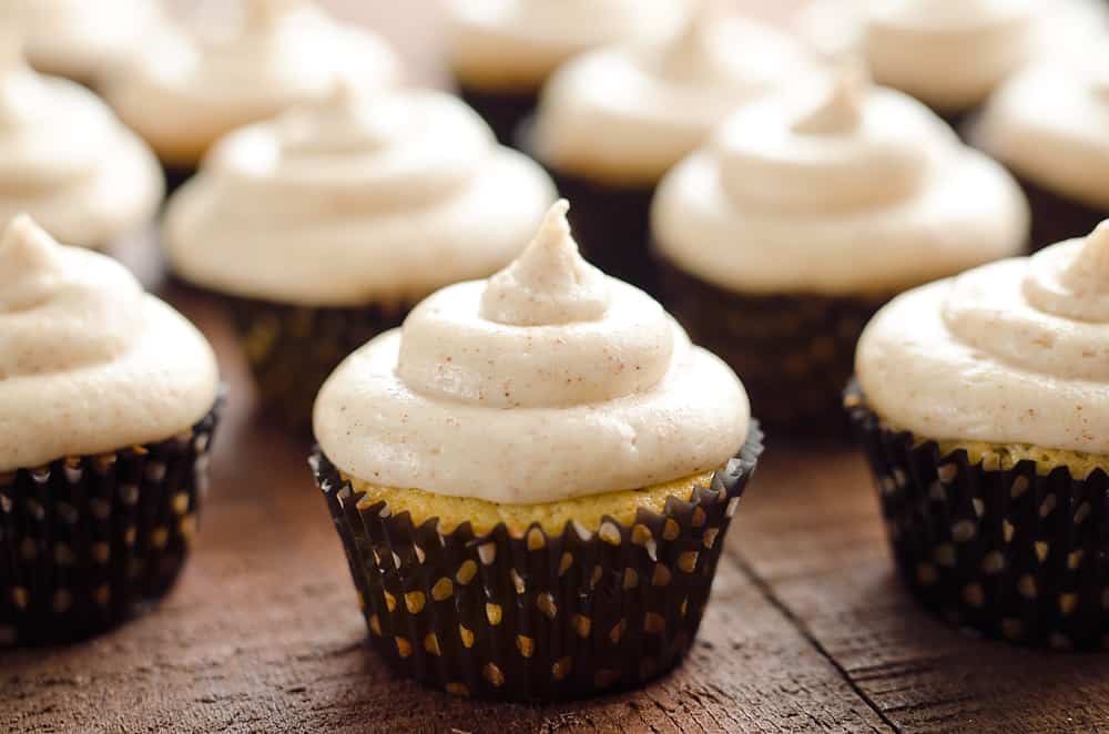 brown buttercream topped cupcakes in black wrappers