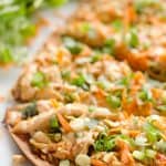Light Thai Peanut Chicken Flatbread is a quick and healthy recipe perfect for a weeknight dinner! A thin and crispy flatbread is topped with Crock Pot Thai Peanut Chicken, cheese and crunchy vegetables and peanuts!