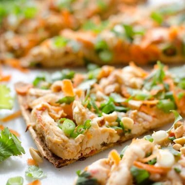 Light Thai Peanut Chicken Flatbread is a quick and healthy recipe perfect for a weeknight dinner! A thin and crispy flatbread is topped with Crock Pot Thai Peanut Chicken, cheese and crunchy vegetables and peanuts!
