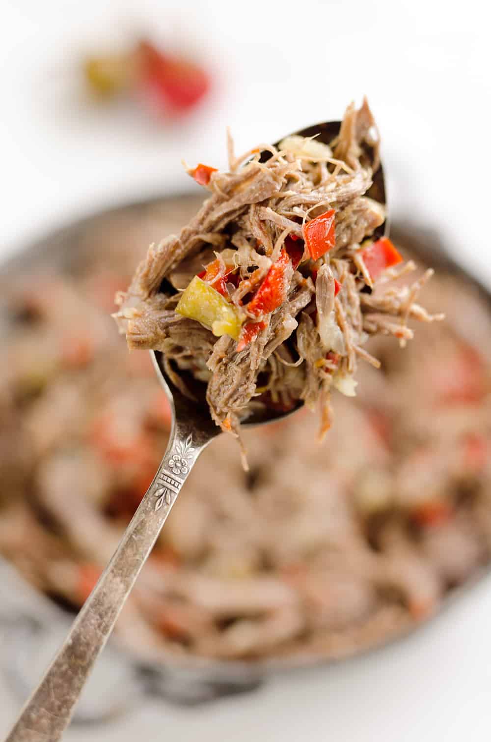 Pressure Cooker Shredded Italian Beef is an easy no fuss recipe made with simple ingredients! Serve this beef along with your favorite veggies for a healthy low-carb dinner idea or pile it high on fresh buns for a delicious sandwich!