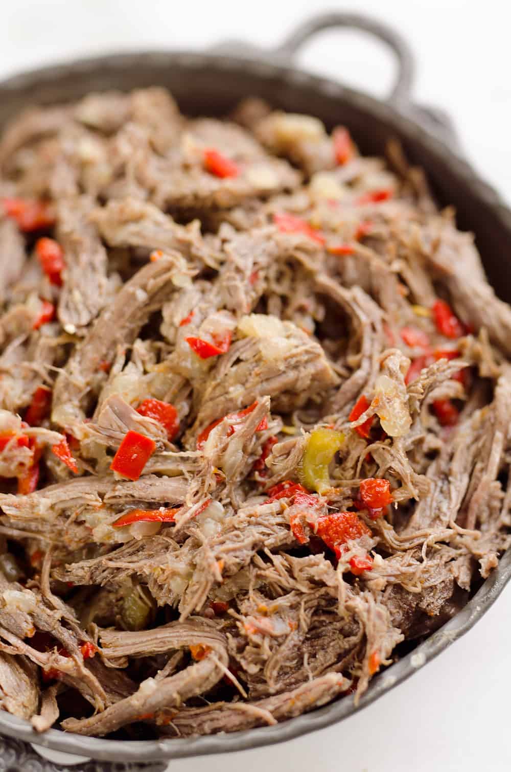 Pressure Cooker Shredded Italian Beef is an easy no fuss recipe made with simple ingredients! Serve this beef along with your favorite veggies for a healthy low-carb dinner idea or pile it high on fresh buns for a delicious sandwich!