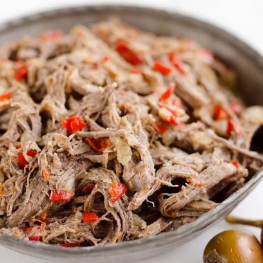 Pressure Cooker Shredded Italian Beef is an easy no fuss recipe made with simple ingredients! Serve this beef along with your favorite veggies for a healthy low-carb dinner idea or pile it high on fresh buns for a delicious sandwich!