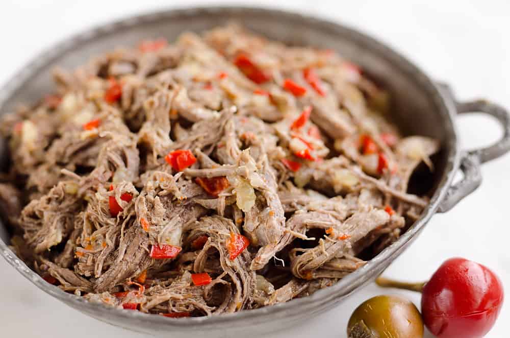Pressure Cooker Shredded Italian Beef is an easy no fuss recipe made with simple ingredients! Serve this beef along with your favorite veggies for a healthy low-carb dinner idea or pile it high on fresh buns for a delicious sandwich!