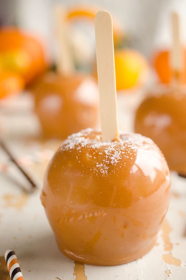 Salted Caramel Apples are fresh tart apples coated in a rich homemade salted caramel for the perfect fall treat!