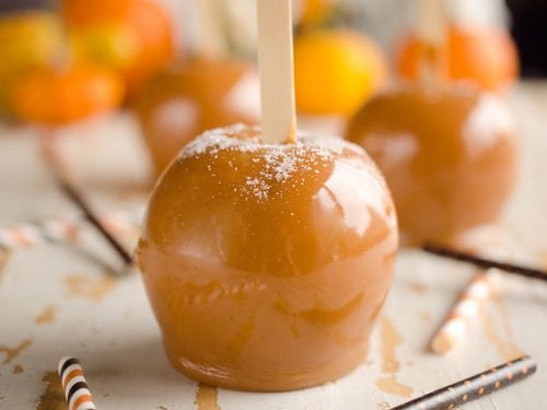 Salted Caramel Apples are fresh tart apples coated in a rich homemade salted caramel for the perfect fall treat!