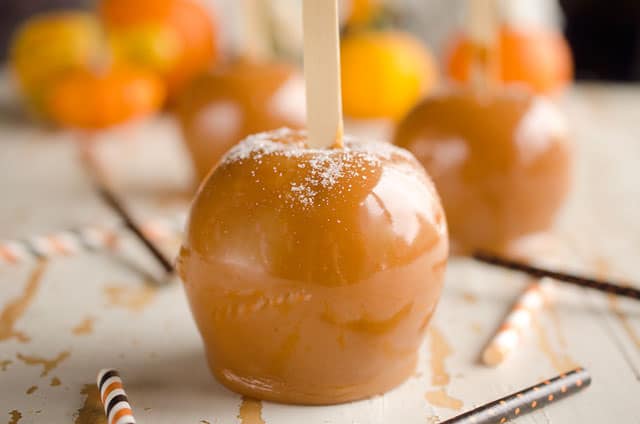 Salted Caramel Apples are fresh tart apples coated in a rich homemade salted caramel for the perfect fall treat!