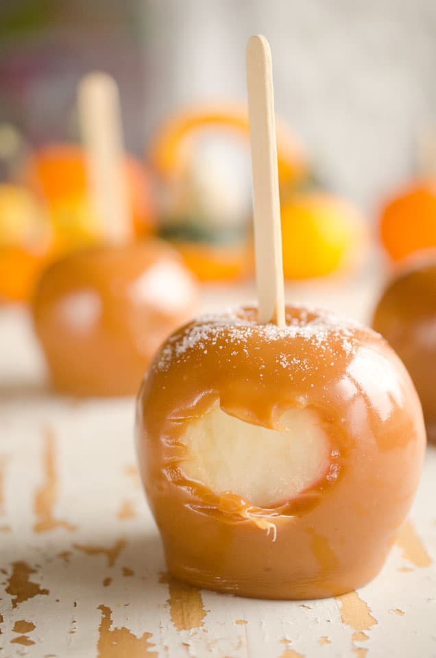 Salted Caramel Apples are fresh tart apples coated in a rich homemade salted caramel for the perfect fall treat!