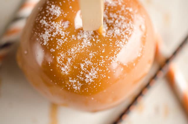 Salted Caramel Apples are fresh tart apples coated in a rich homemade salted caramel for the perfect fall treat!