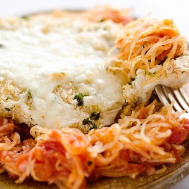 Skinny Spaghetti Squash Chicken Parmesan is a healthy twist on the traditional classic. Lightly breaded chicken breasts are baked and served with low-carb spaghetti squash and marinara sauce for a comforting dinner your family will ask for again and again!