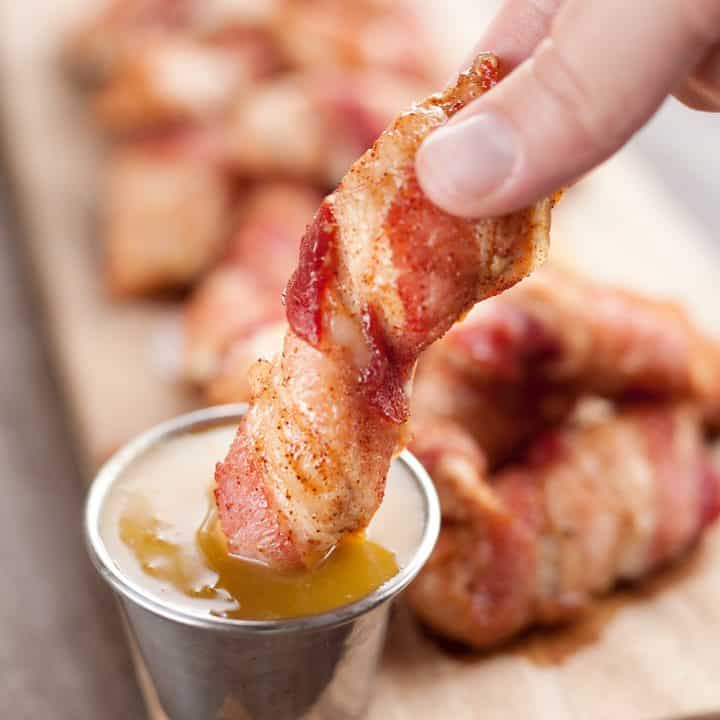 Sweet & Spicy Bacon Wrapped Turkey Tenders are a delicious appetizer paired with a homemade honey mustard for the ultimate game day finger food! They also make a great dinner idea with a side of rice and veggies.