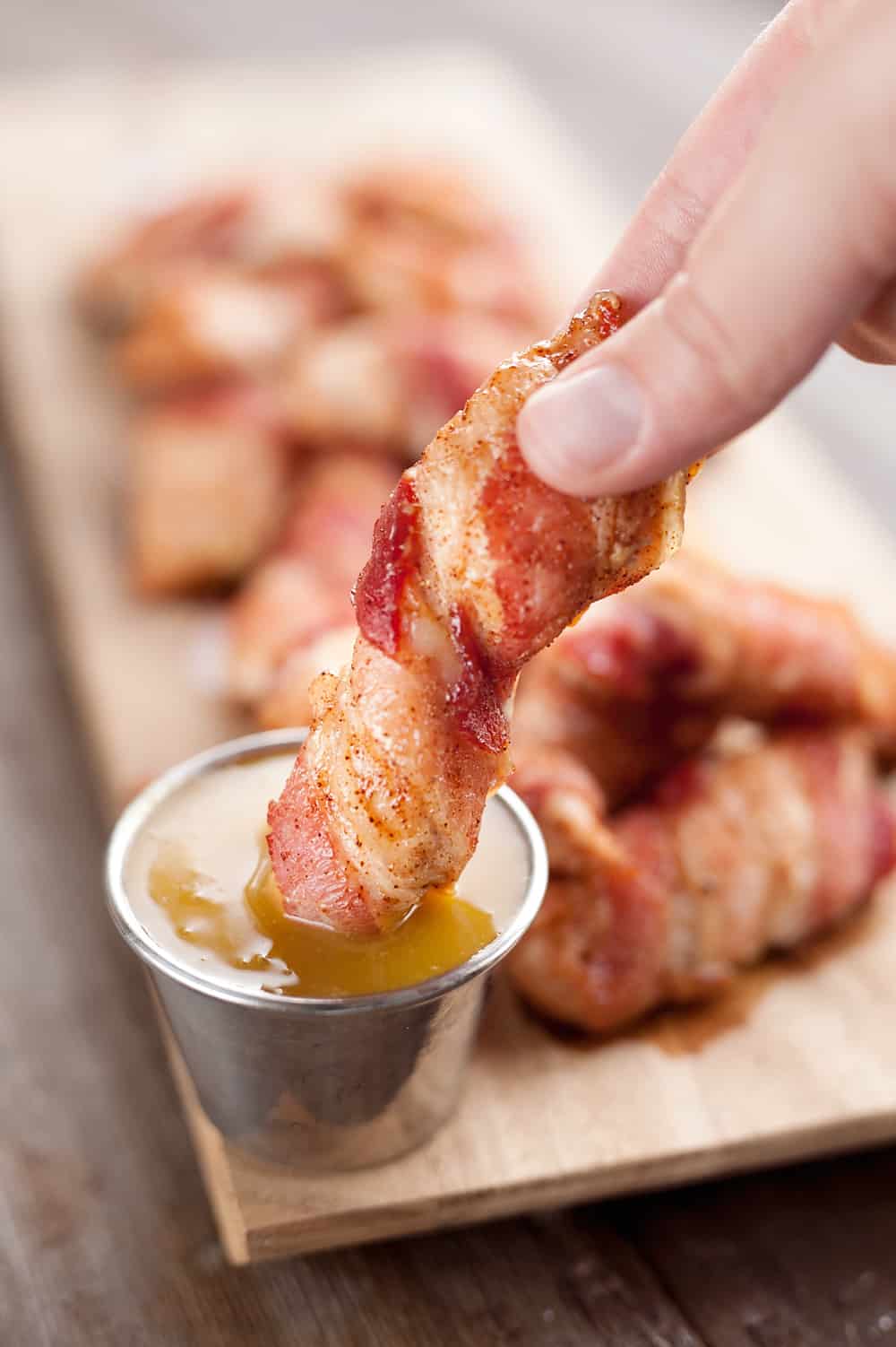 Sweet & Spicy Bacon Wrapped Turkey Tenders are a delicious appetizer paired with a homemade honey mustard for the ultimate game day finger food! They also make a great dinner idea with a side of rice and veggies. 