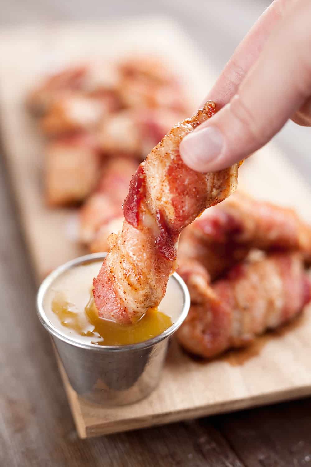 Sweet & Spicy Bacon Wrapped Turkey Tenders are a delicious appetizer paired with a homemade honey mustard for the ultimate game day finger food! They also make a great dinner idea with a side of rice and veggies.