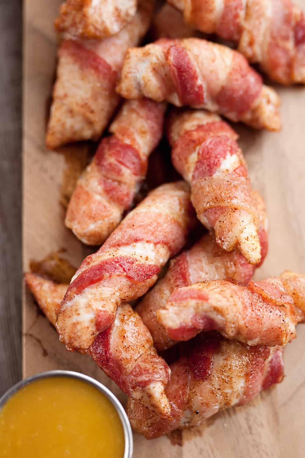 Sweet & Spicy Bacon Wrapped Turkey Tenders are a delicious appetizer paired with a homemade honey mustard for the ultimate game day finger food! They also make a great dinner idea with a side of rice and veggies. 