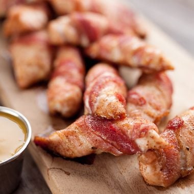 Sweet & Spicy Bacon Wrapped Turkey Tenders are a delicious appetizer paired with a homemade honey mustard for the ultimate game day finger food! They also make a great dinner idea with a side of rice and veggies.