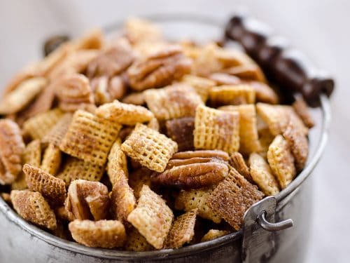 Sweet & Spicy Pecan Snack Mix is a delicious treat with Chex coated in a spicy cinnamon brown sugar mixture and tossed with pecans. This delicious Chex Mix will disappear quickly at your next holiday gathering!