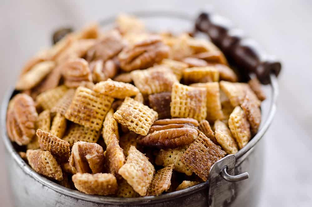 Sweet & Spicy Pecan Snack Mix is a delicious treat with Chex coated in a spicy cinnamon brown sugar mixture and tossed with pecans. This delicious Chex Mix will disappear quickly at your next holiday gathering! 