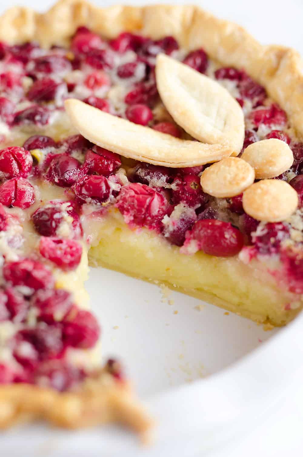 Cranberry Orange Custard Pie is a festive and unique pie to enjoy during the holiday season. Silky sweet custard laced with orange zest and tart cranberries fill a flaky pie crust for a delicious dessert you will love!