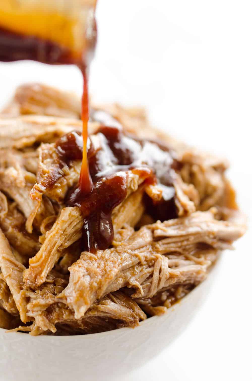 Pressure Cooker BBQ Pulled Pork is an easy three ingredient recipe that makes for tender and delicious pork that is perfect for sandwiches or wonderful paired with rice and vegetables for a healthy dinner idea.