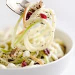 Spiralized Apple Cranberry Salad on fork with walnut