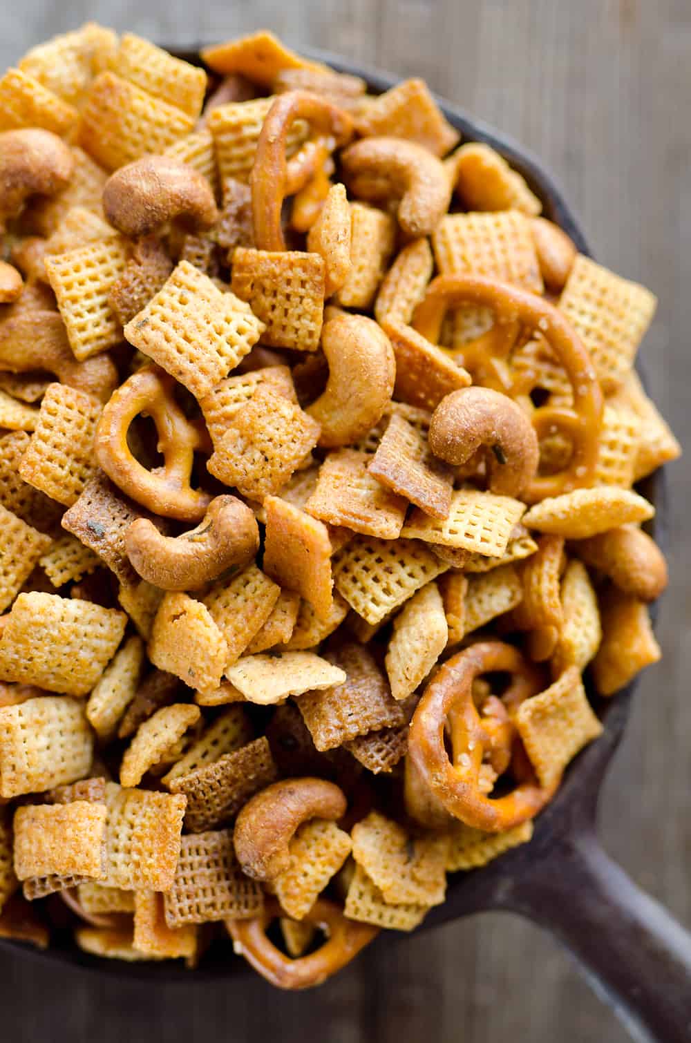 Buffalo Ranch Snack Mix is an easy treat perfect for the big game or holidays. Chex Mix is combined with pretzels and cashews and tossed in a spicy buffalo ranch sauce for a twist on your traditional snack mix. 