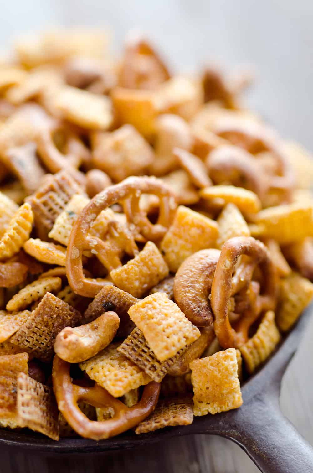 Buffalo Ranch Snack Mix is an easy treat perfect for the big game or holidays. Chex Mix is combined with pretzels and cashews and tossed in a spicy buffalo ranch sauce for a twist on your traditional snack mix. 