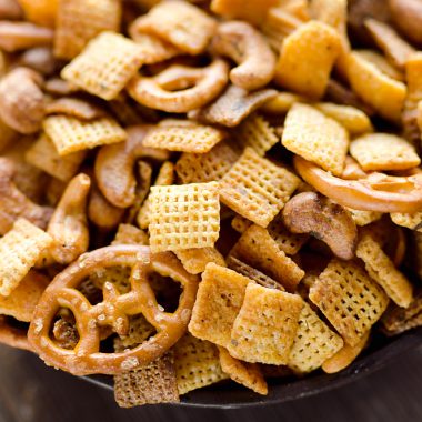 Buffalo Ranch Snack Mix is an easy treat perfect for the big game or holidays. Chex Mix is combined with pretzels and cashews and tossed in a spicy buffalo ranch sauce for a twist on your traditional snack mix.