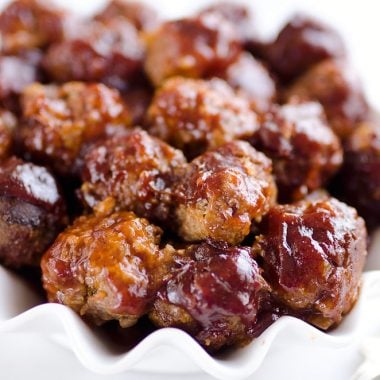 Crock Pot Cheddar BBQ Meatballs make for a flavor packed dinner paired with potatoes or a fantastic appetizer for the big game or holiday bash! Tender beef meatballs loaded with onion and cheese are simmered in your favorite BBQ sauce for a wonderful recipe made in your slow cooker.